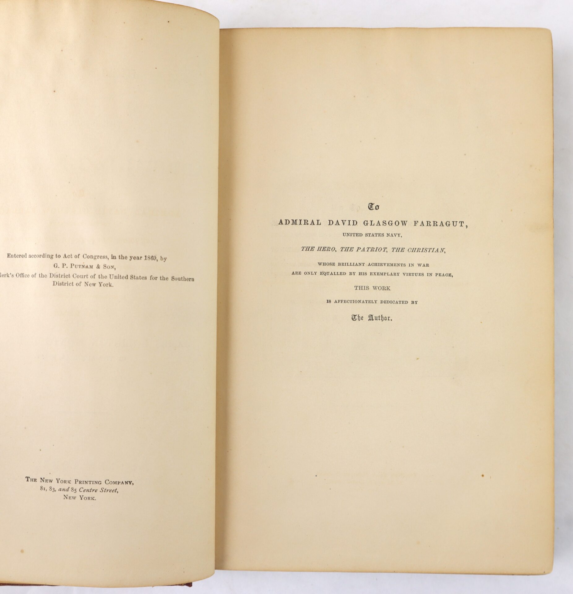 An open book displays a dedication page to Admiral David Glasgow Farragut on the right and publication information on the left.