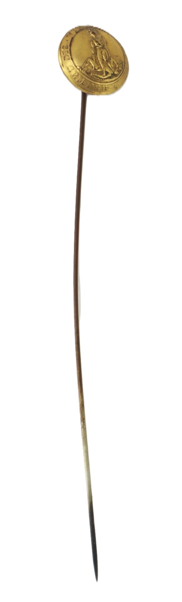 A gold stick pin featuring a round medallion with an embossed design; the pin tapers to a point.