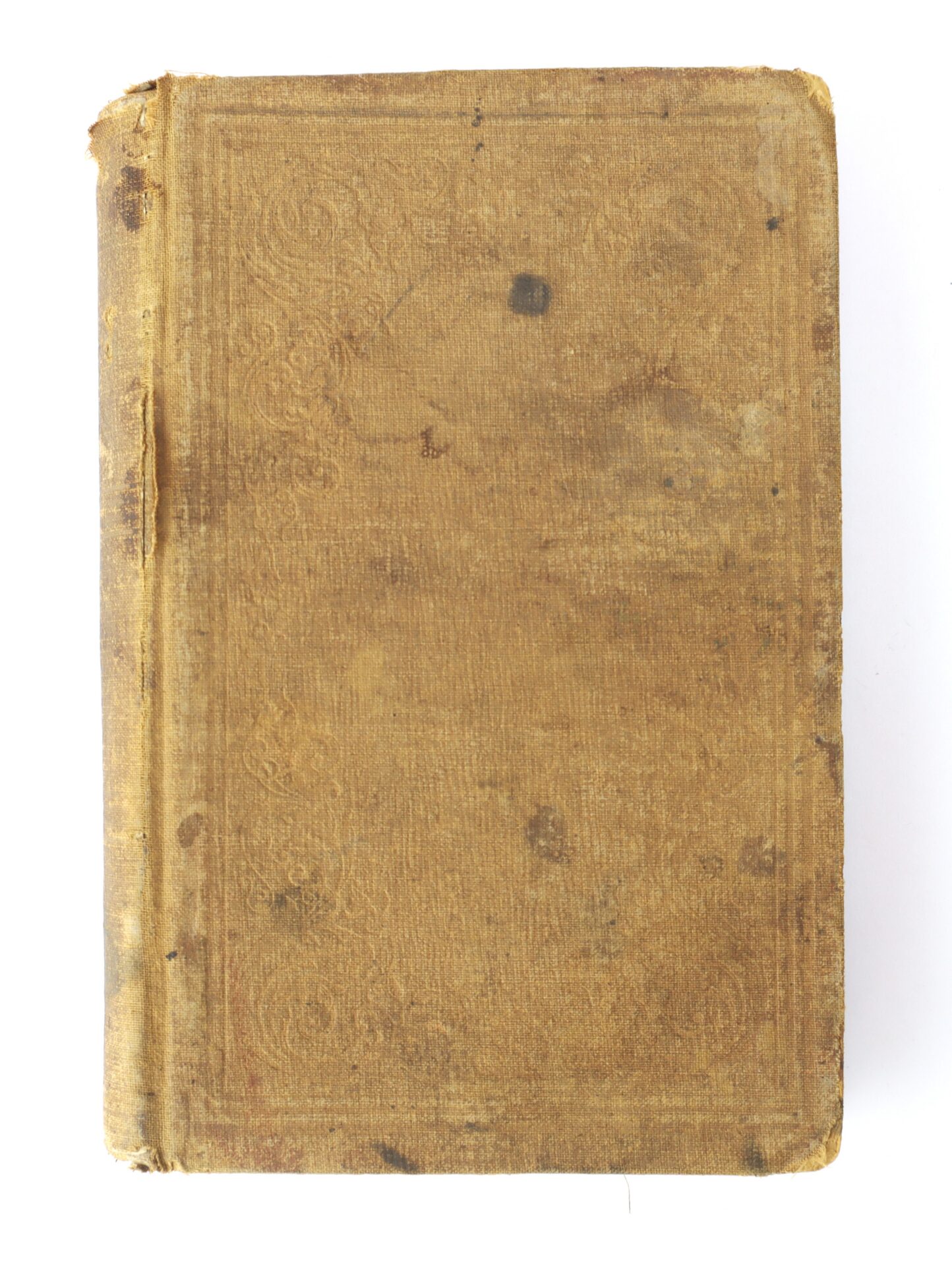 A worn, old hardcover book with a faded brown cover and visible stains, showing signs of age and use.