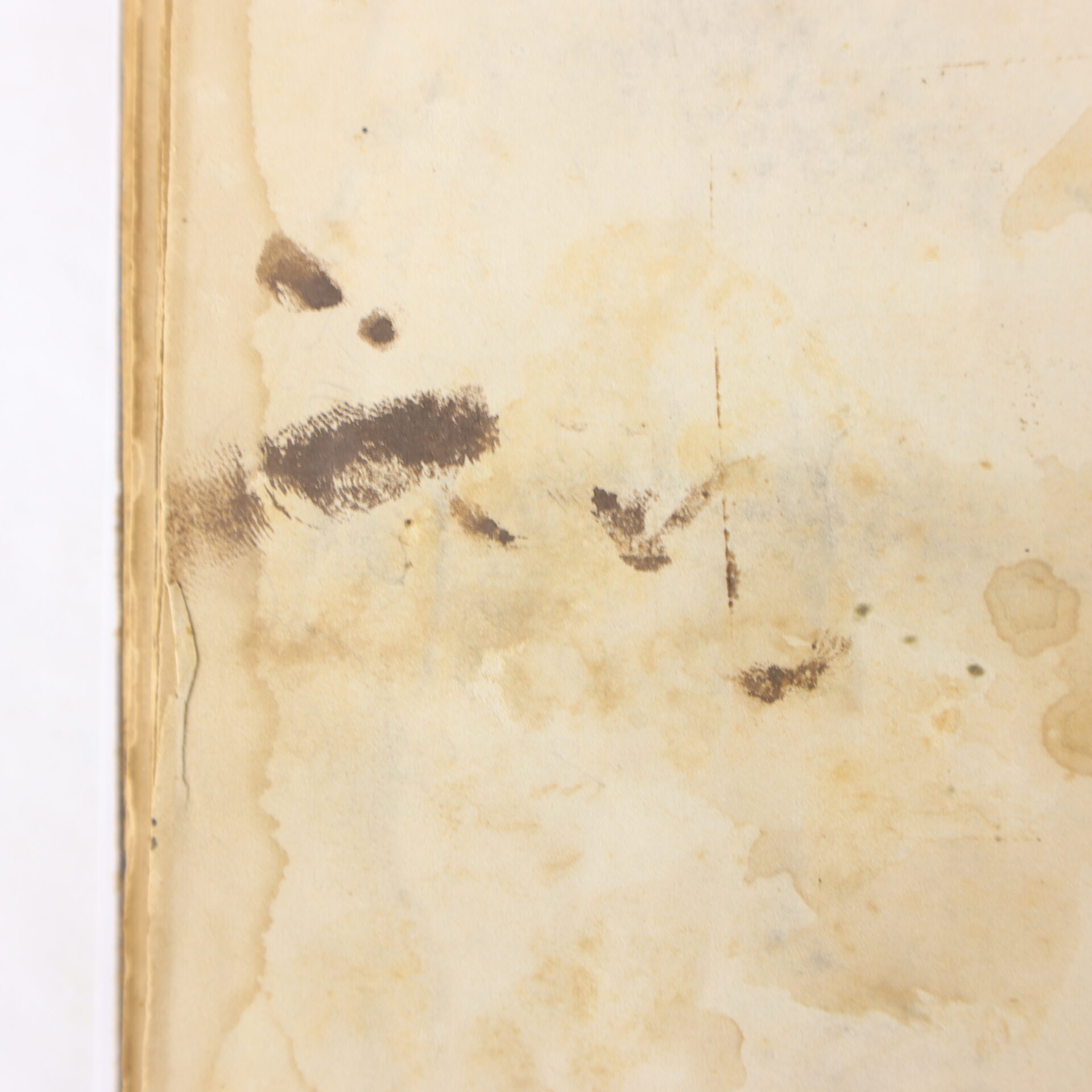 Stained and aged paper with visible water damage and dark smudges, including a fingerprint mark near the left edge.