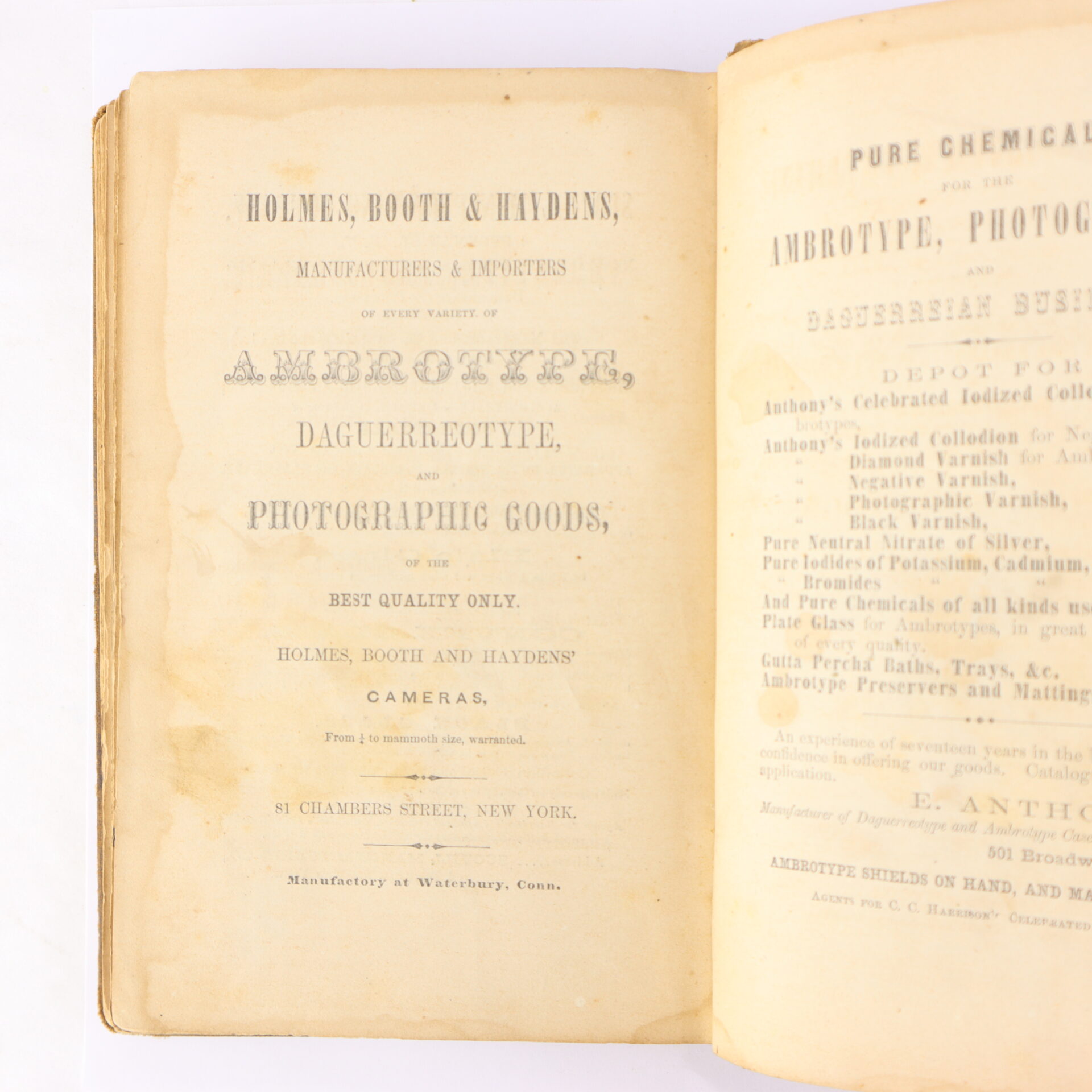 Open book showing a title page advertising Holmes, Booth & Haydens, manufacturers of ambrotype, daguerreotype, and photographic goods, located at 51 Chambers Street, New York.