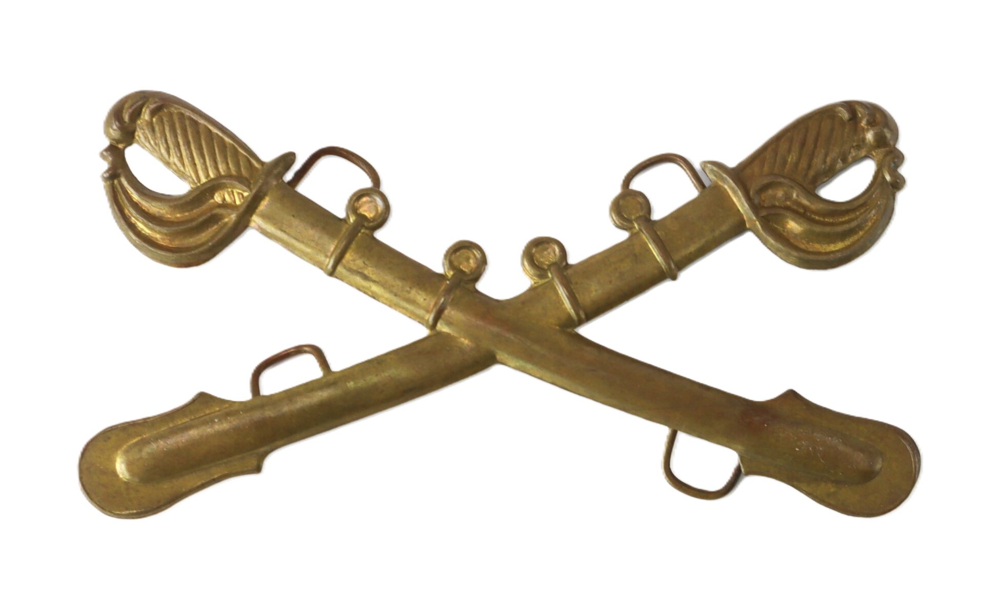 Two crossed brass cavalry sabers with detailed hilts, typically used as a military insignia.