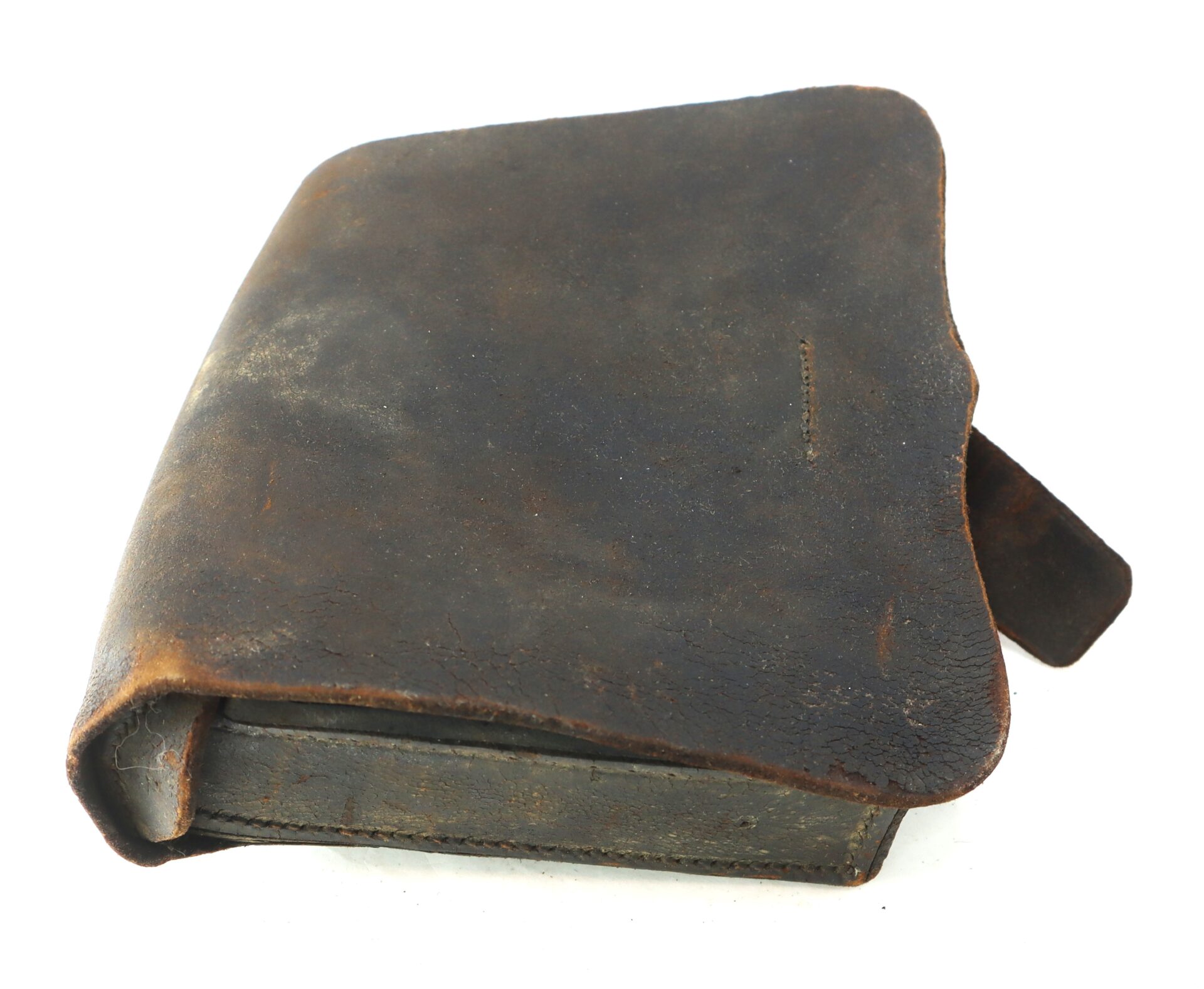 A worn, dark brown leather pouch with a flap cover, showing visible signs of aging and use, placed on a white background.