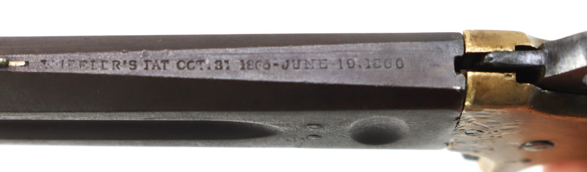 Close-up of a firearm barrel engraved with the text “PATENT'S PAT OCT.31 1860–JUNE 19.1860” near a brass component.