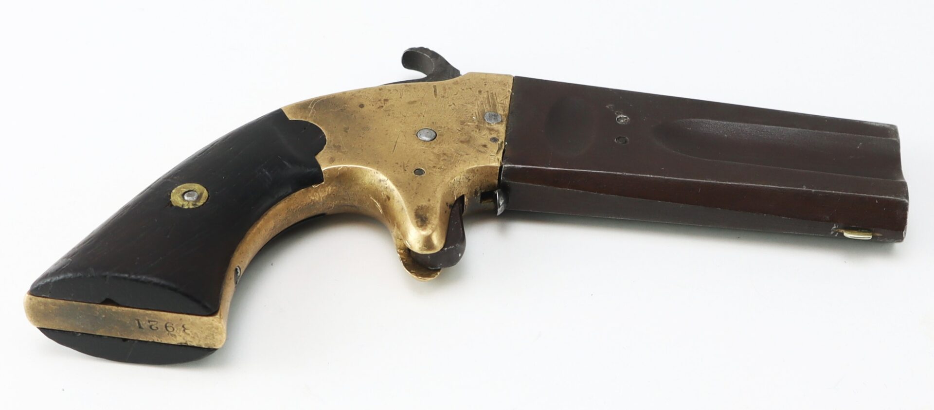 A vintage derringer-style pistol with a brass frame and dark wood grip is shown on a plain white background.