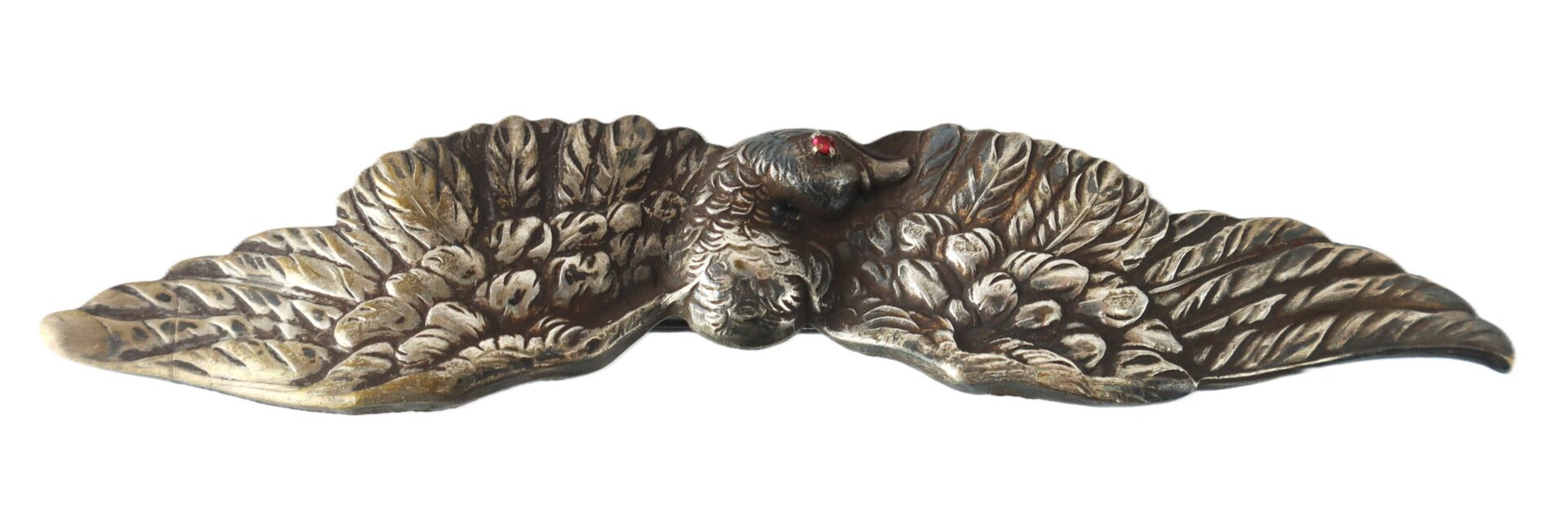 Bronze decorative piece depicting a bird with spread wings, featuring detailed feather textures and a small red accent on the head.
