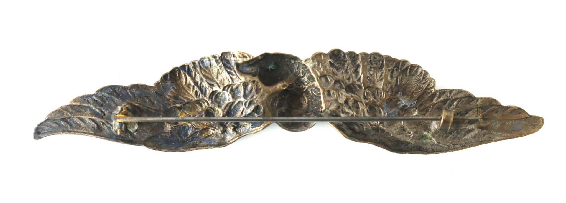 Bronze brooch with a pin clasp, shaped like two textured leaves joined at the center.
