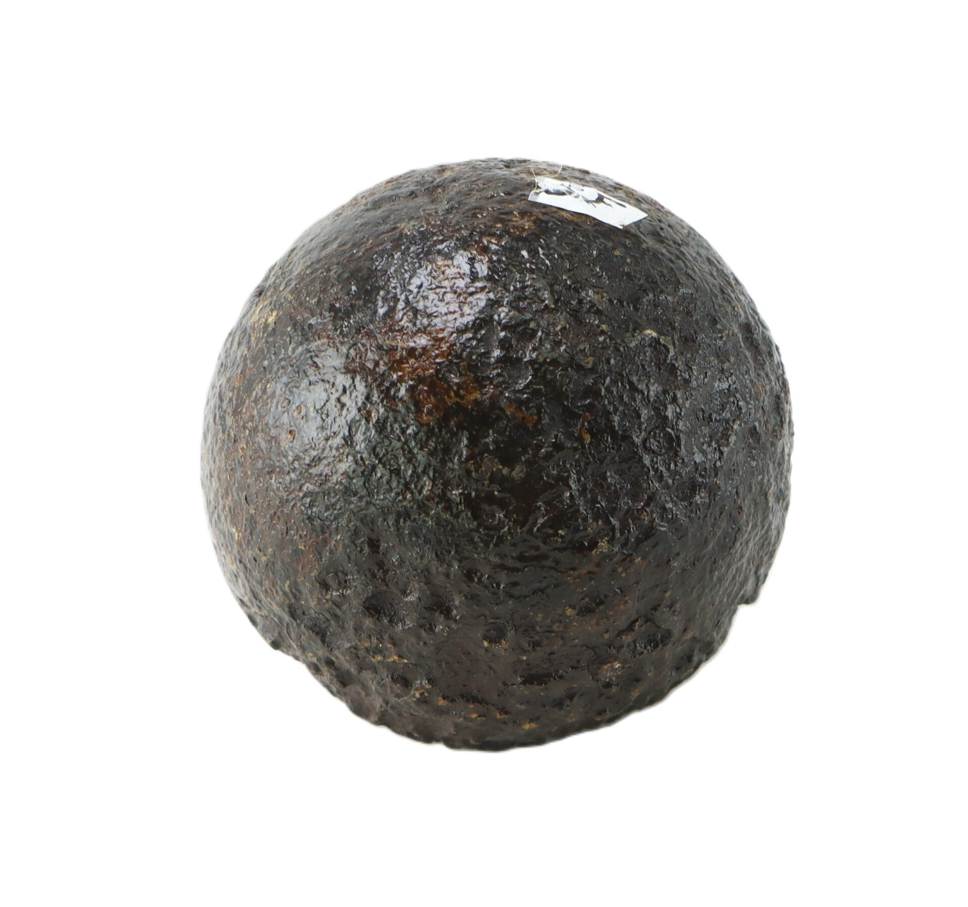 A single, round, dark brown, textured object resembling a cannonball or large stone sphere, photographed against a plain white background.