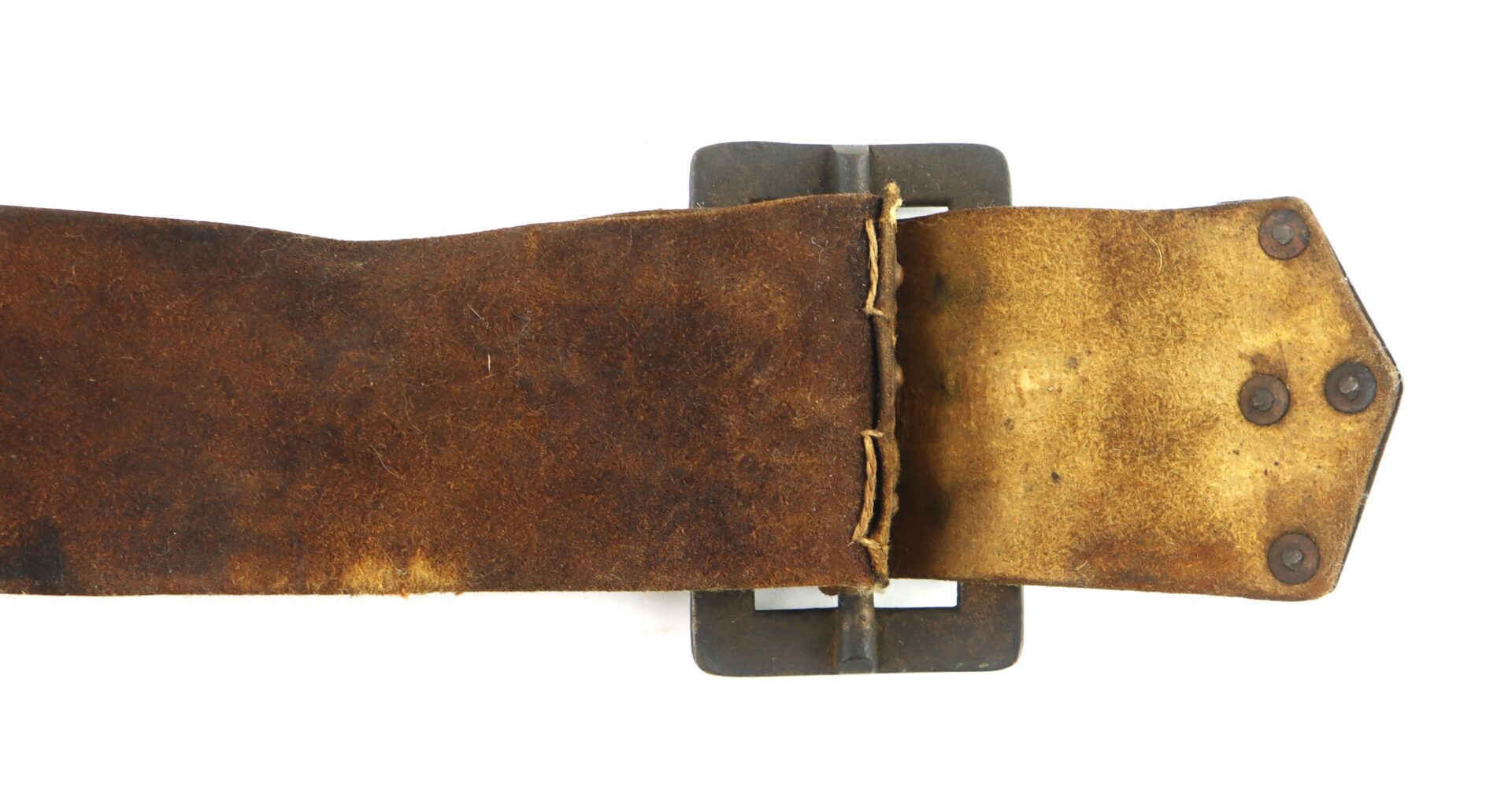 A close-up of a worn brown leather belt with visible stitching and rivets, attached to a dark metal buckle, against a white background.
