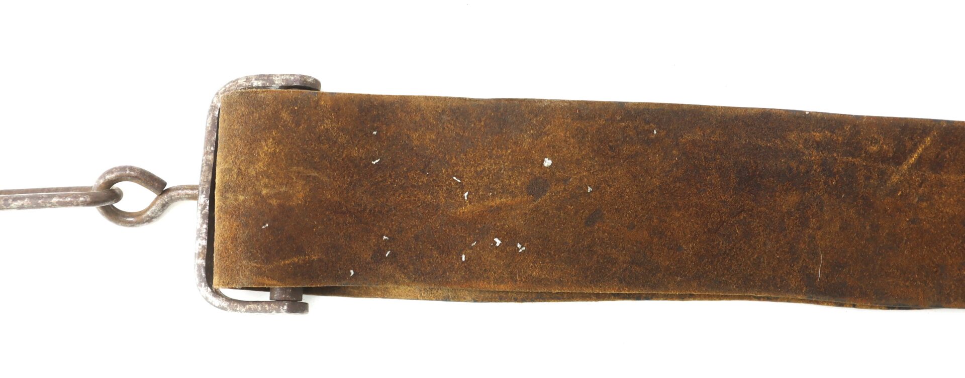 Close-up of a worn, brown leather strap with metal hardware attached on the left side, photographed against a white background.
