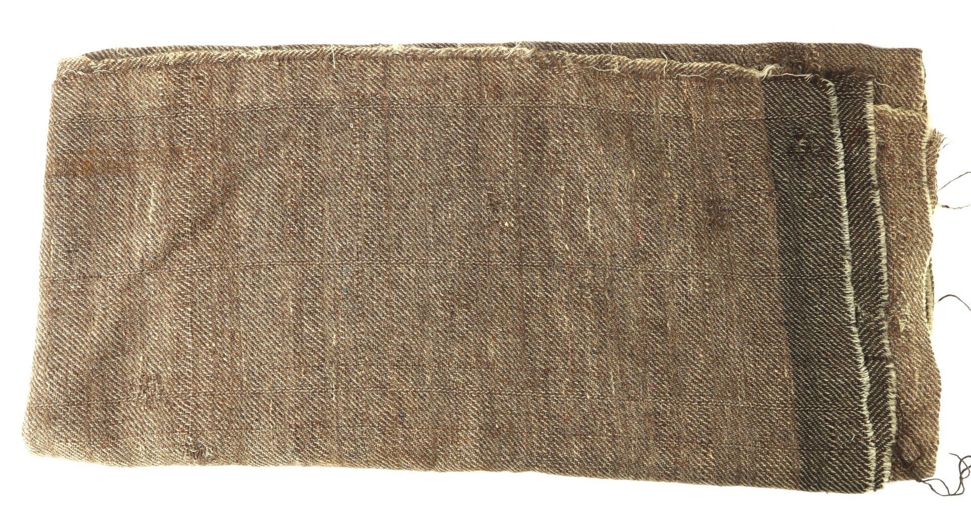 A folded piece of coarse, brown woven fabric with frayed edges and a dark stripe along one end.