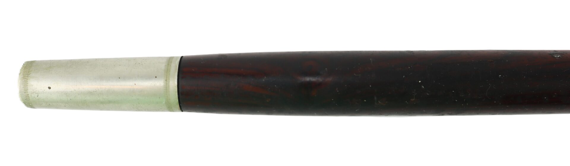 A close-up of a wooden walking stick with a silver-colored metal cap on one end.