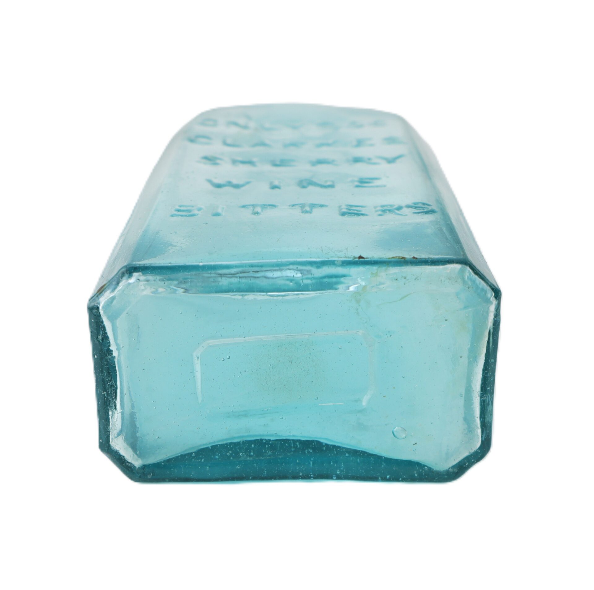 A clear aqua glass bottle with an embossed label, shown from the base on a white background.