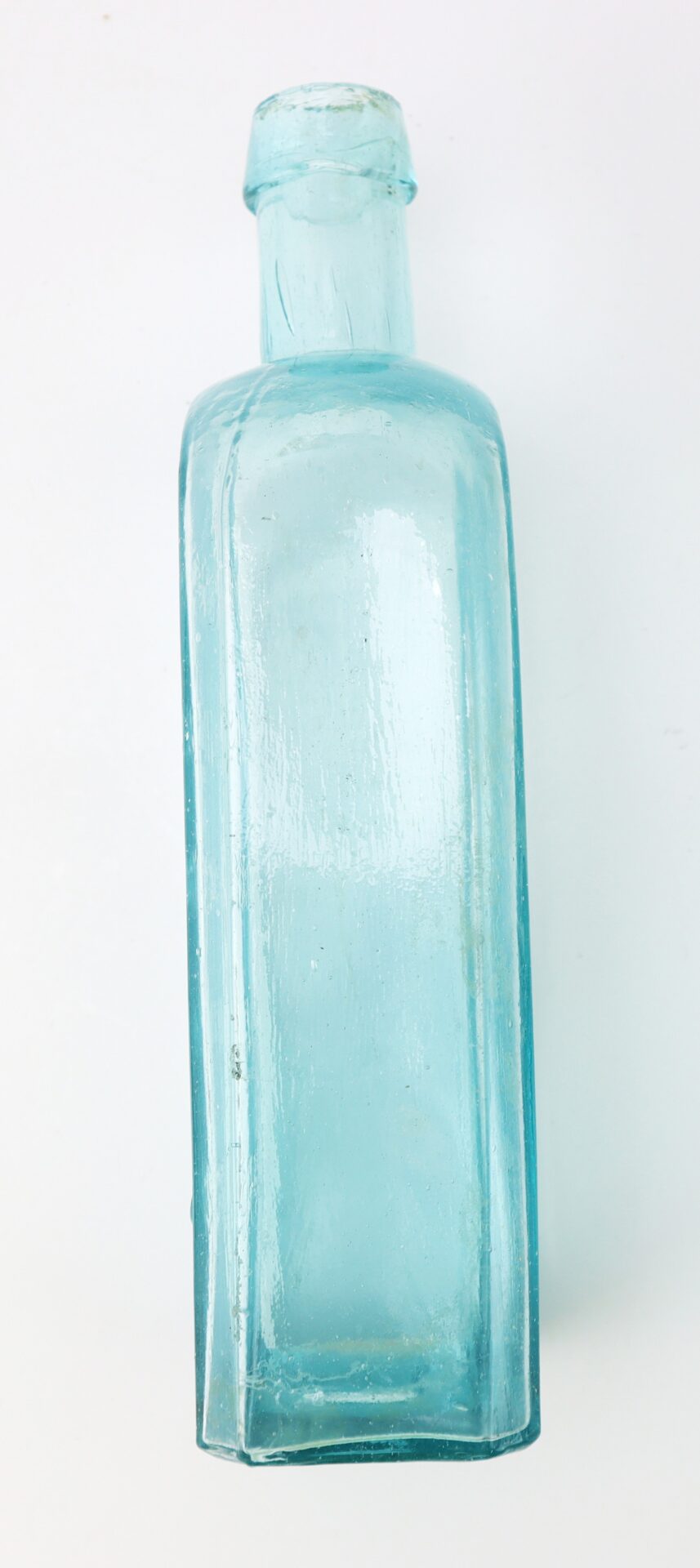 A clear, light blue glass bottle with a rectangular body and a short neck, viewed against a plain white background.