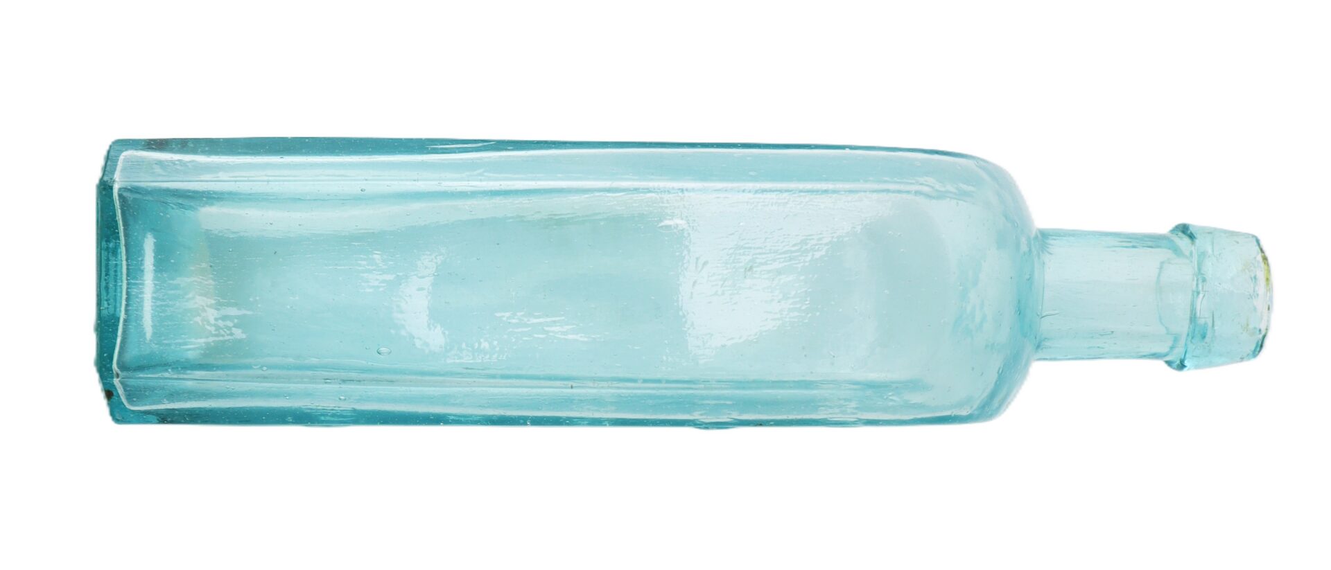A clear blue-green glass bottle with a rectangular body and short neck, shown lying on its side against a white background.
