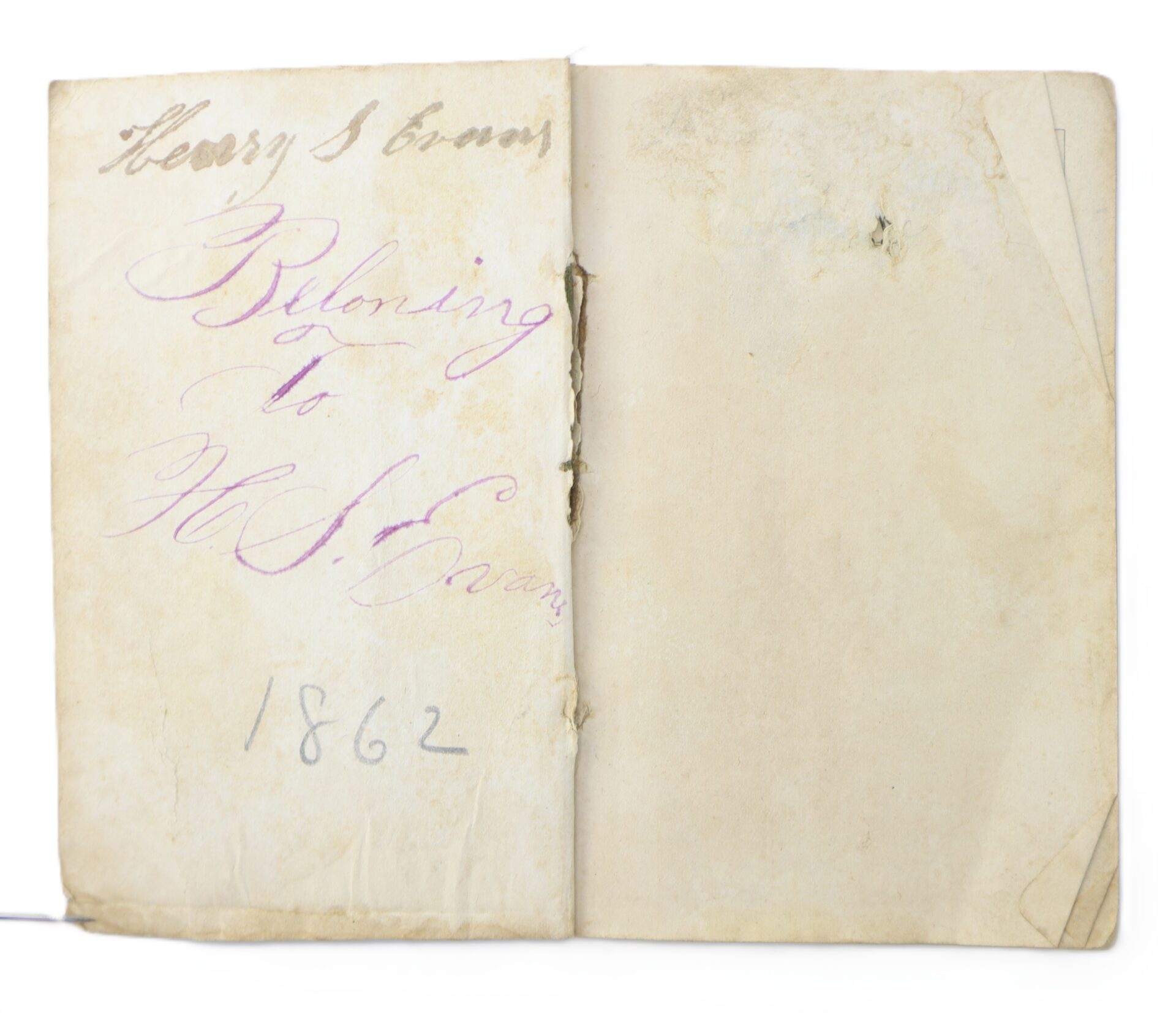 An old, worn paper booklet opened to the first page, inscribed with "Henry S. Evans," "Belonging to H.S. Evans," and the year "1862" in handwritten ink.