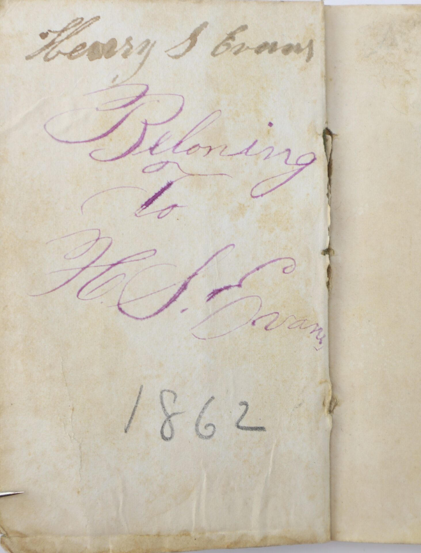A worn, yellowed page with handwritten text: "Henry S Evans," "Belonging to H. S. Evans," and the year "1862" in ink.