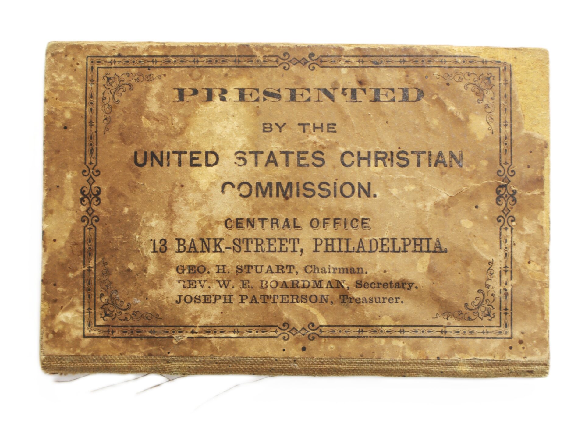 A worn plaque reading "Presented by the United States Christian Commission, Central Office, 13 Bank-Street, Philadelphia" with names of chairman, secretary, and treasurer.