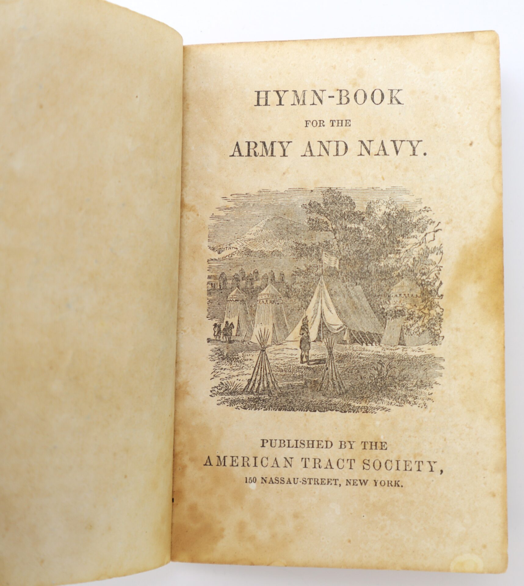 Open book showing the title page of “Hymn-Book for the Army and Navy,” with a tent illustration and publication details by the American Tract Society, New York.
