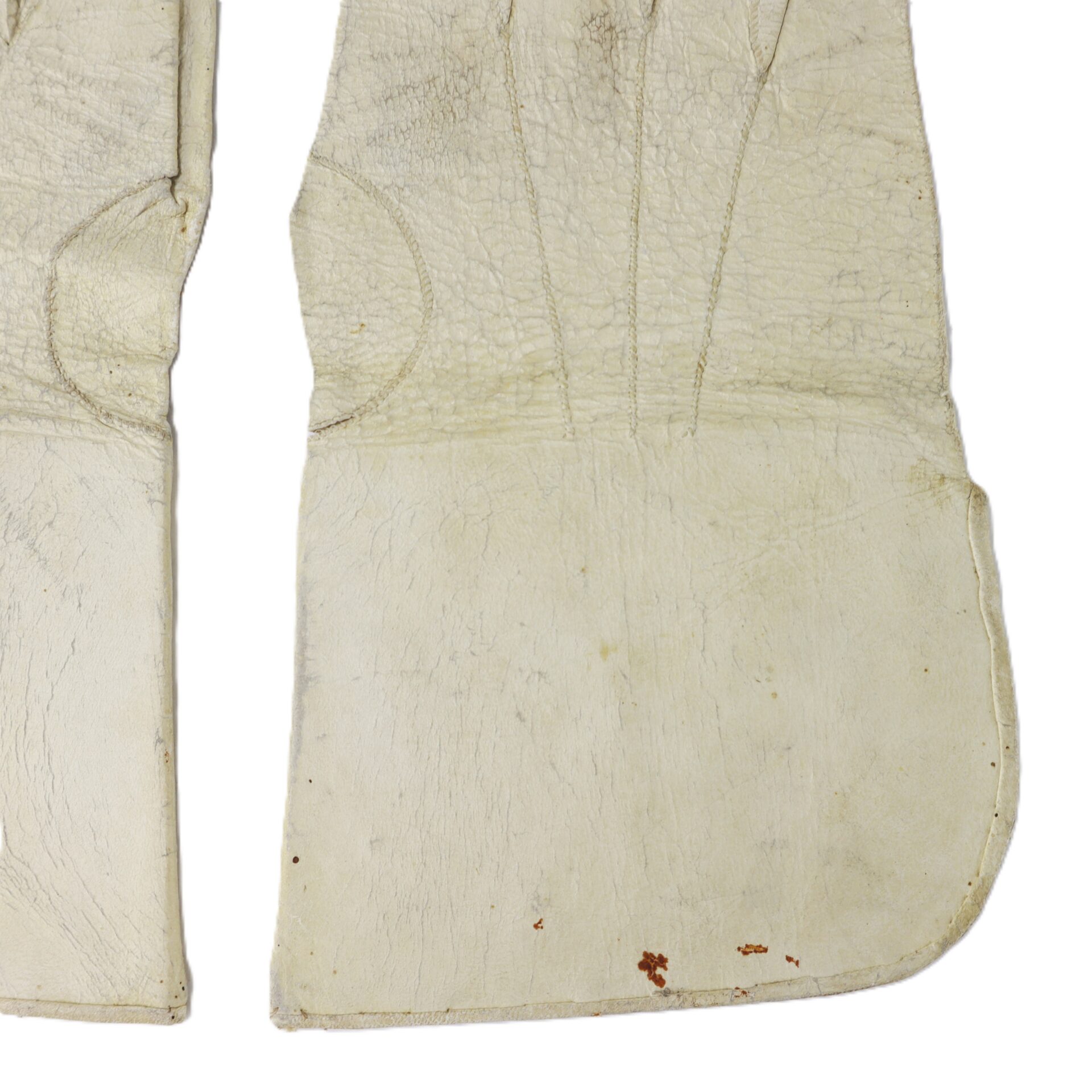 Two white leather gloves with visible seams and some brown stains on the lower part of the right glove.