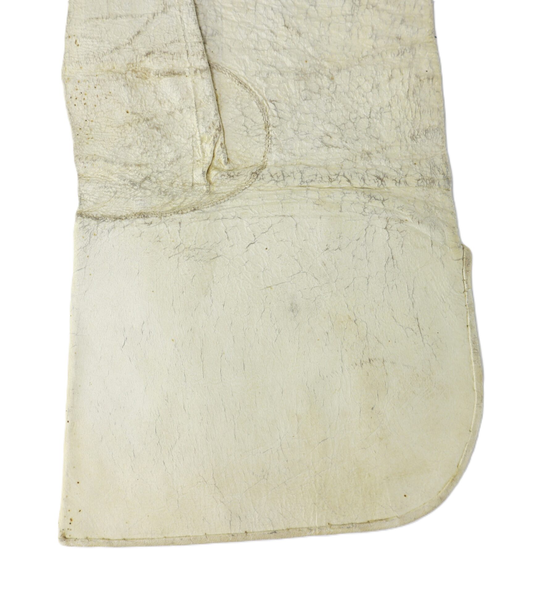 A close-up view of a worn, off-white leather glove with visible creases and texture.