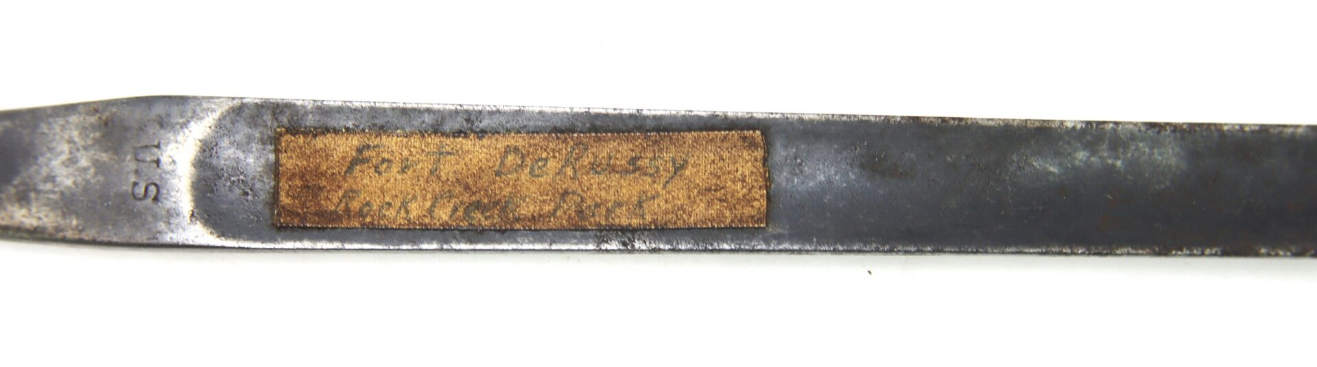 A close-up of a metal tool marked "U.S." with a worn, rectangular label that reads "Fire - Delassy / Marking Bar.