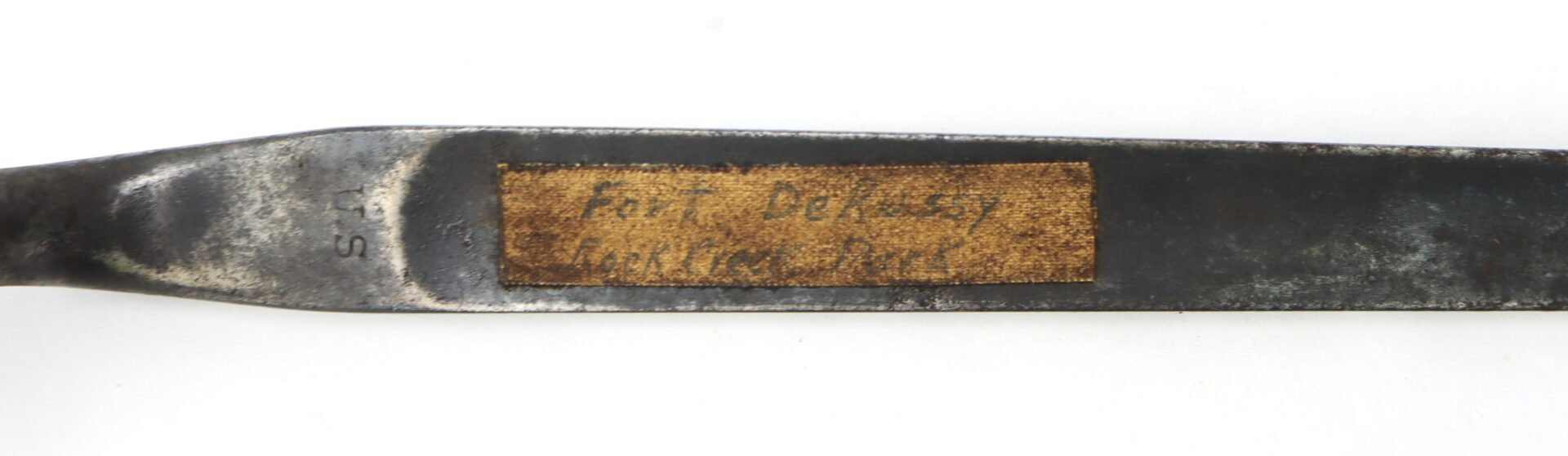 A close-up of a metal tool with a worn rectangular label that reads "For Jersey Walking Plow.