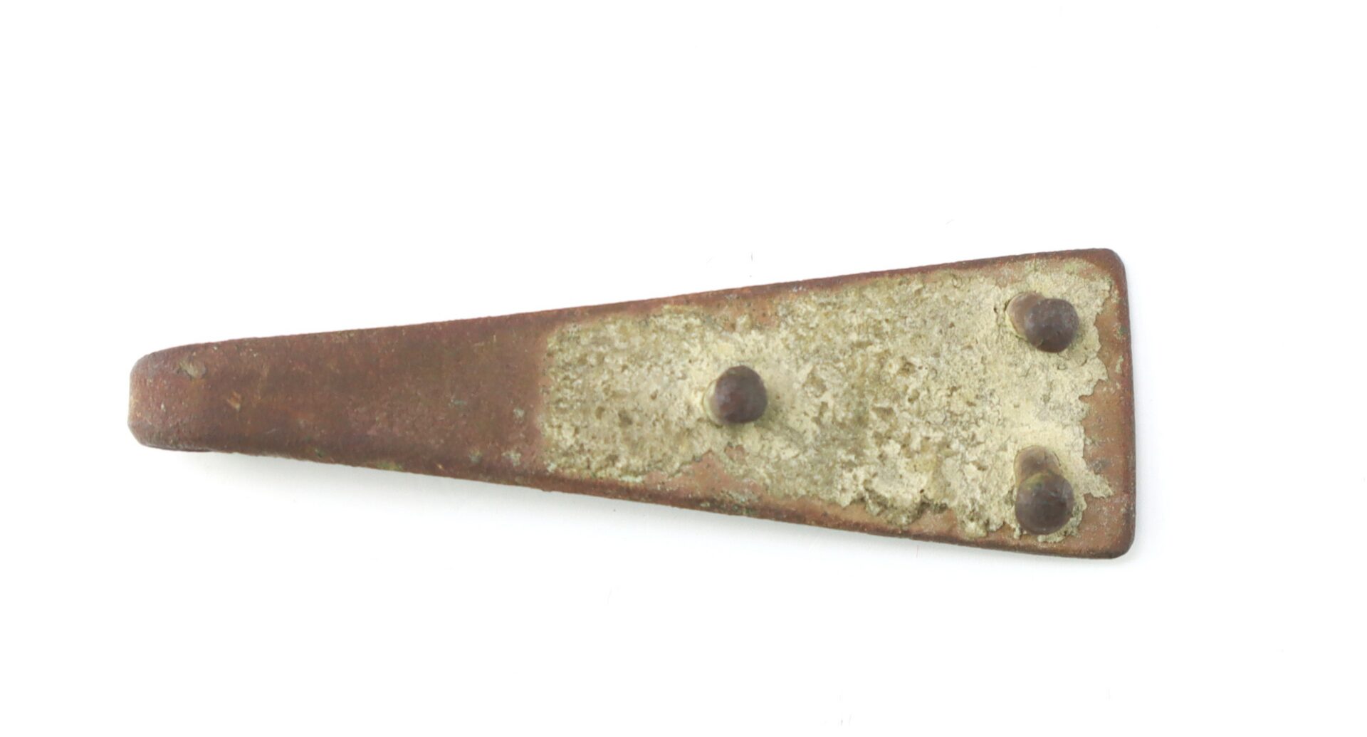A rusty, flat, trapezoidal metal object with three raised rivets, photographed against a white background.