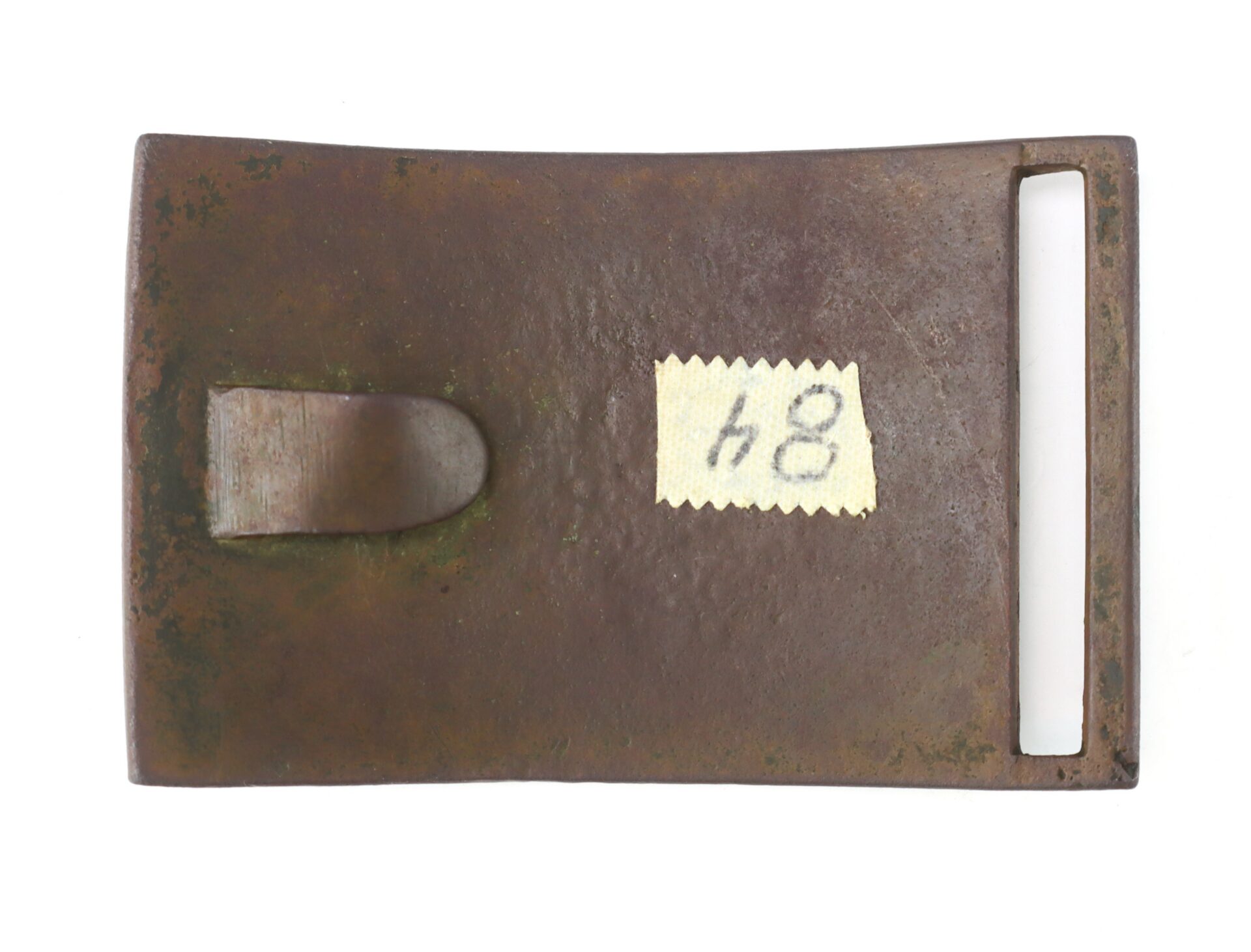 Rusty rectangular metal belt buckle with a rectangular slot on one end, a hook on the other, and a small label marked "48" attached to the surface.