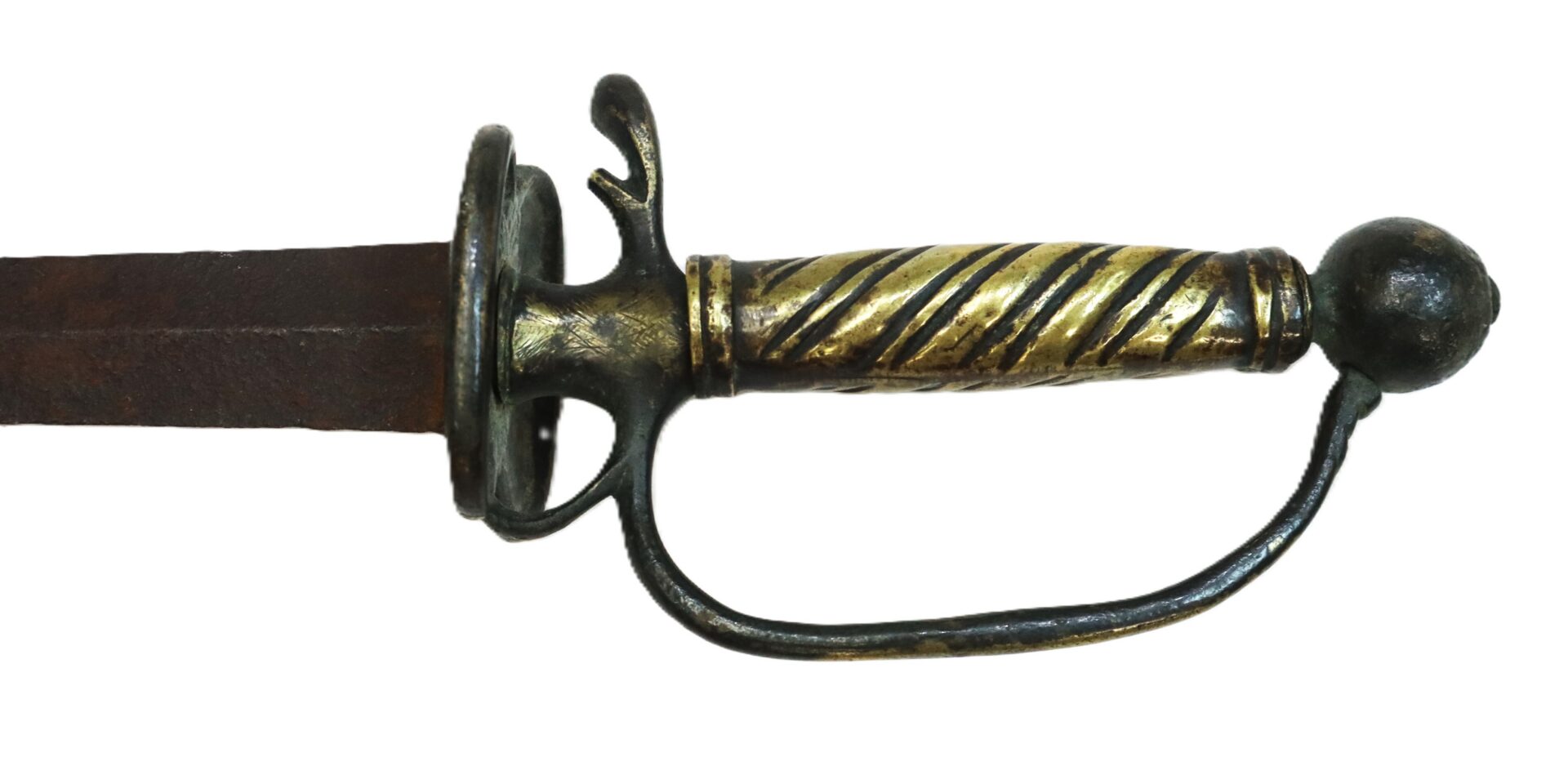 Close-up of an antique sword’s hilt with a brass and black spiral handle, a curved handguard, and part of a rusty blade on a white background.