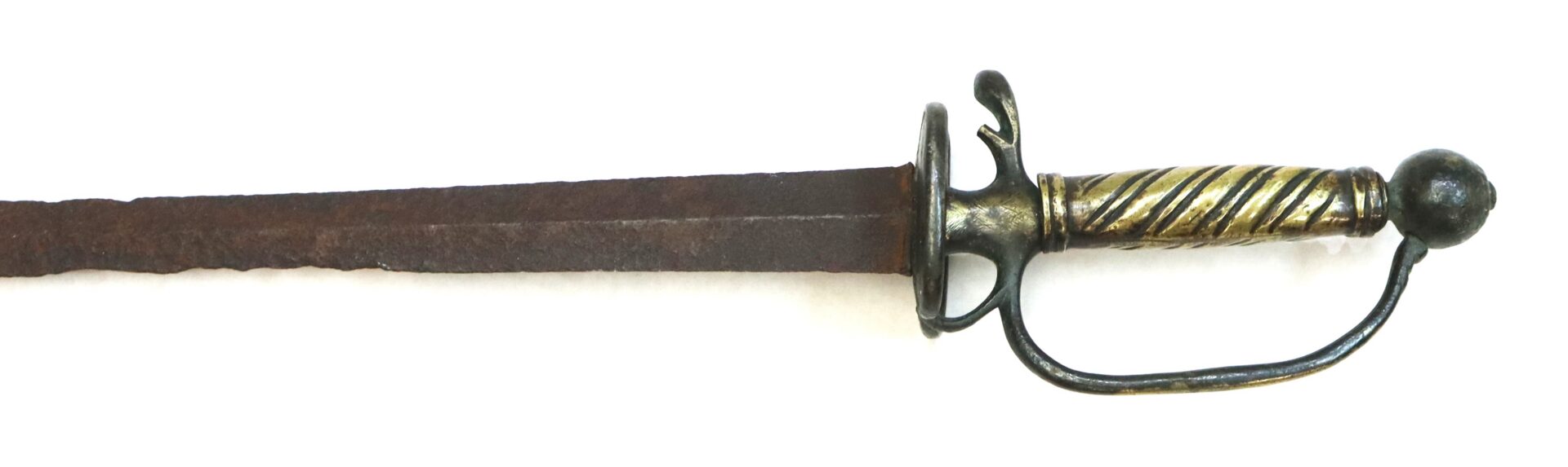 A close-up of an antique sword with a rusted blade and an ornate, gold-colored hilt, shown against a white background.