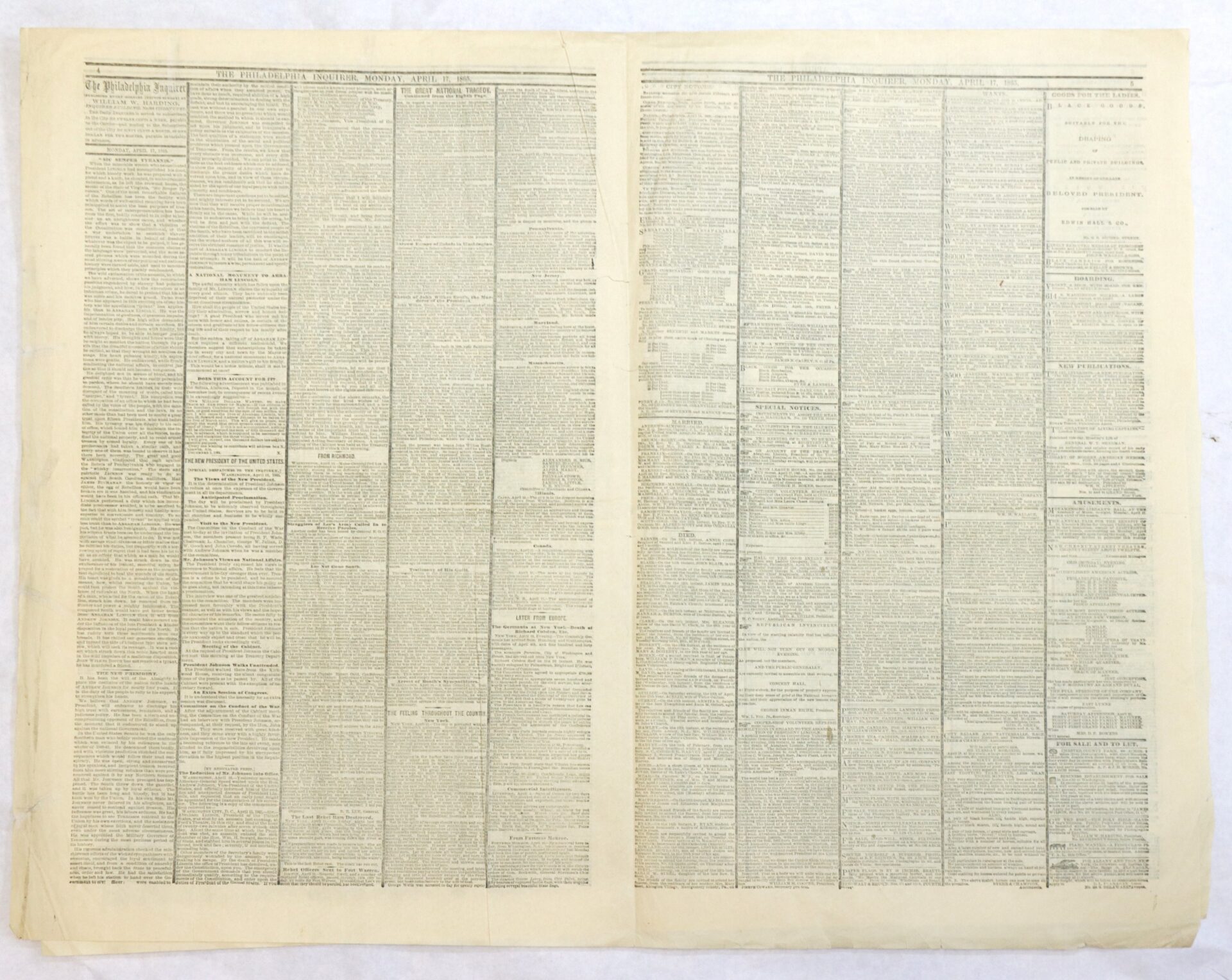 Open, two-page spread of an old newspaper with densely packed, small black text in multiple columns on light-colored paper. No images or visible headlines stand out.
