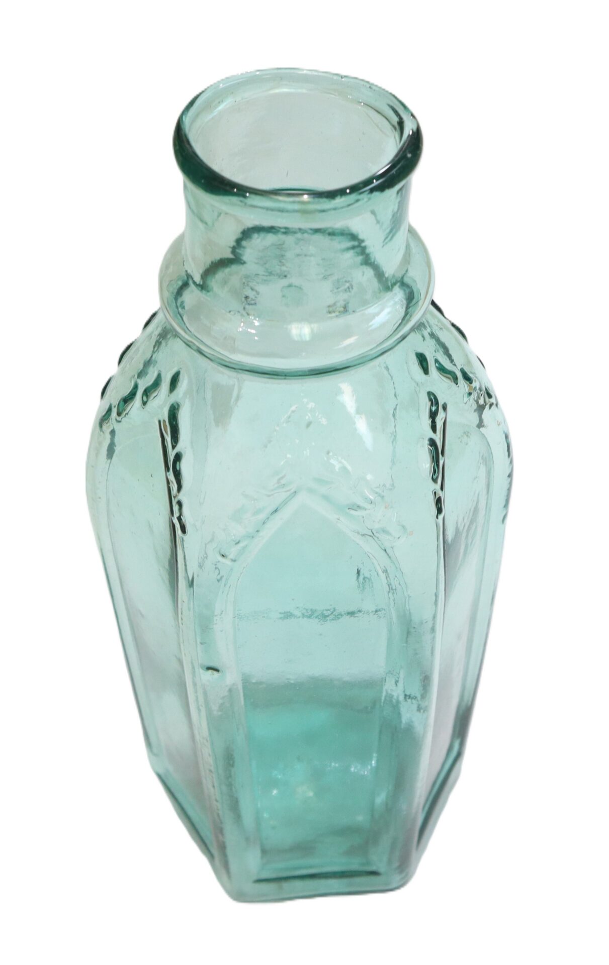 Clear, hexagonal glass bottle with a short neck and embossed patterns, shown on a white background.