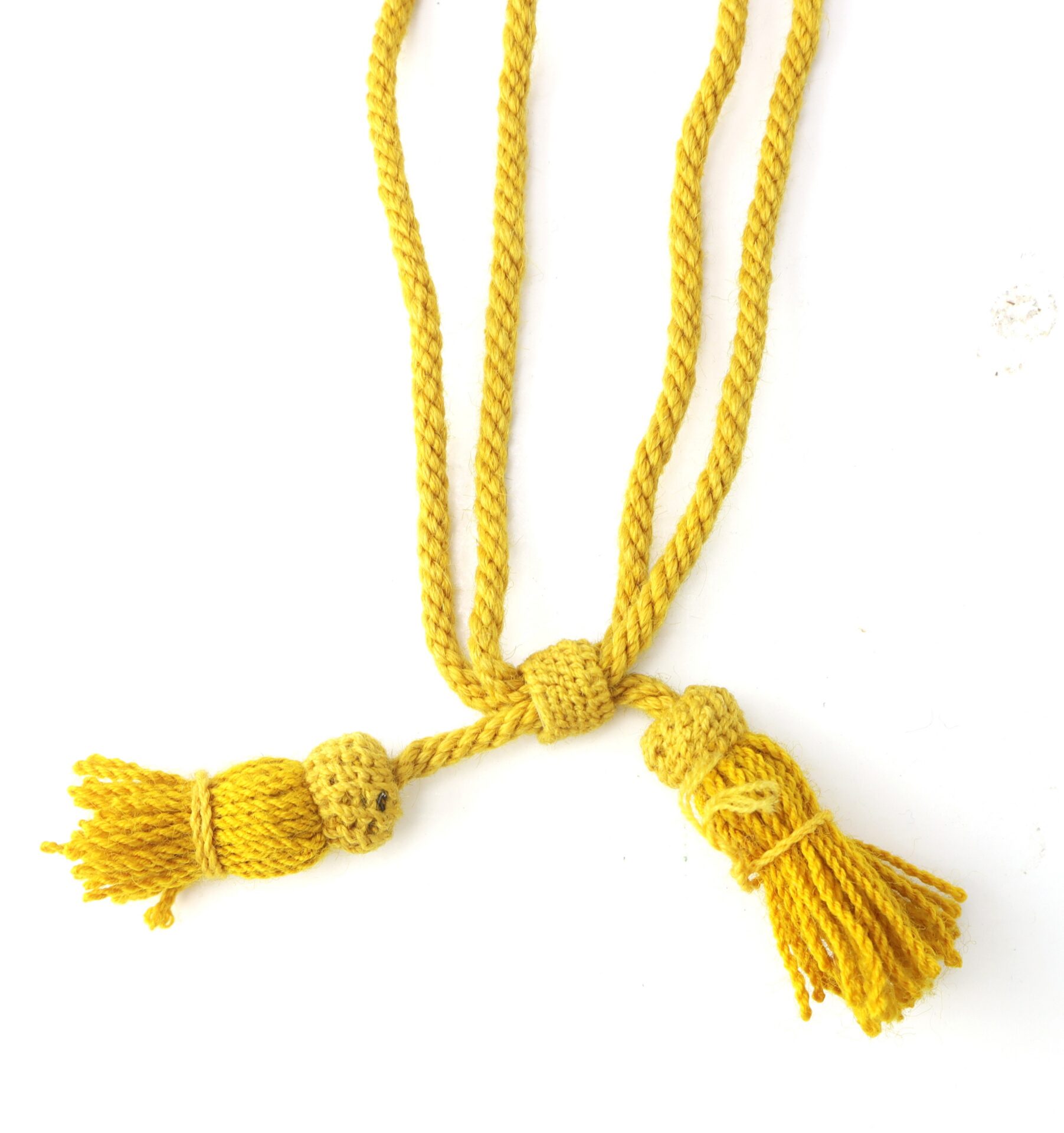 A yellow twisted cord with two tassels on each end, displayed against a white background.