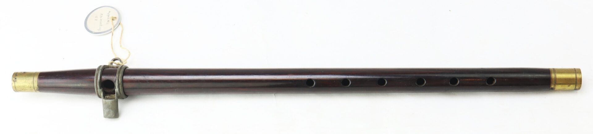 The Civil War–Era Fife with Brass Fittings, Gettysburg Provenance, is a wooden flute featuring six finger holes and a metal tuning slide attached with a tag—an authentic artifact from the period.