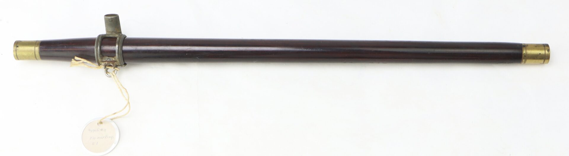 A Civil War–era fife with brass fittings and Gettysburg provenance, featuring a string-tied tag at one end, displayed on a white background.