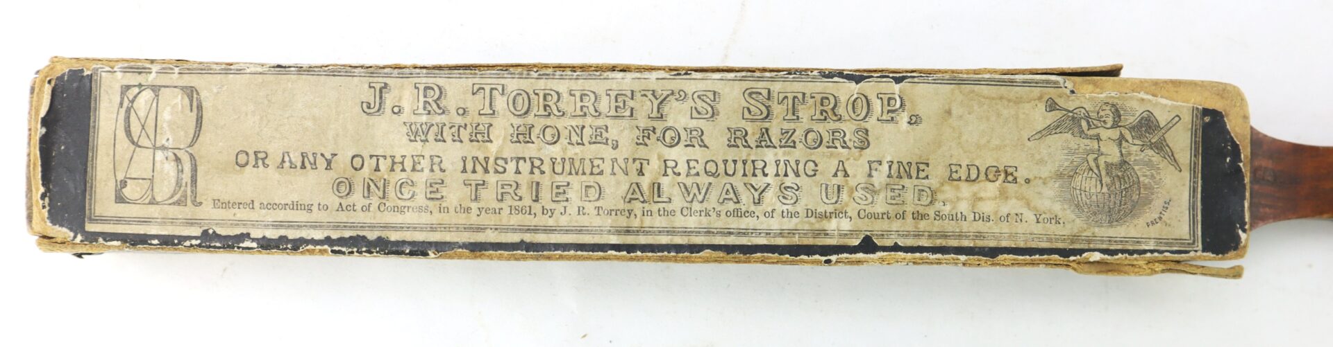 A vintage J.R. Torrey’s Patent Razor Strop, dated 1861, with a printed label advertising its use for honing razors and fine-edged instruments and featuring the slogan, “Once tried always used.”.