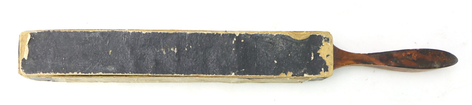 J.R. Torrey’s Patent Razor Strop, dated 1861, is a rectangular leather strop with a worn black surface and wooden handle, used for sharpening straight razors.