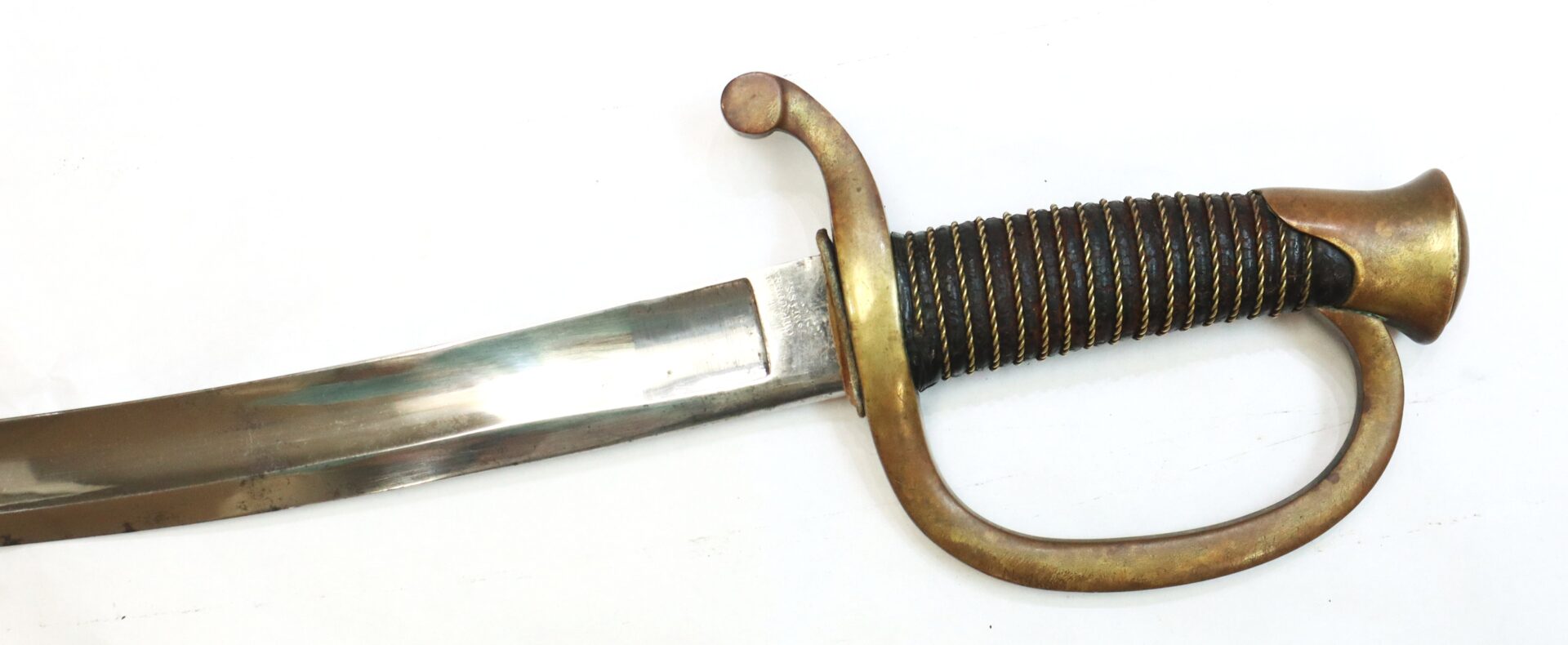 A curved sword with a metal guard, ribbed handle wrapped in wire, and a wide blade, displayed on a white background.