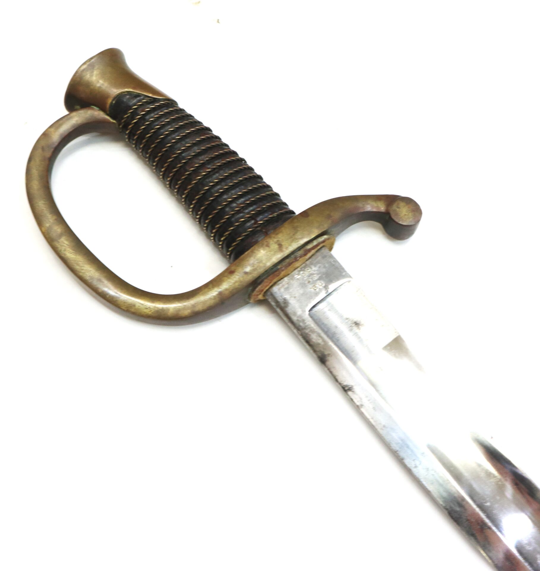 A close-up of an antique sword with a curved brass guard, coiled grip, and partially visible straight blade against a white background.