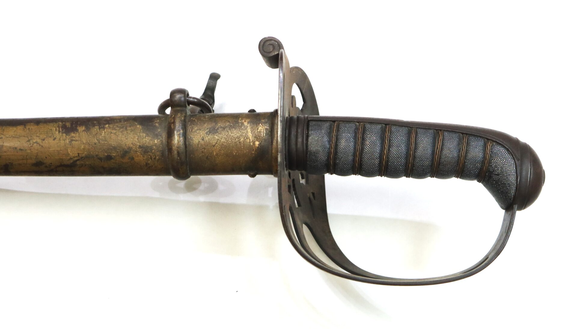 A close-up of an antique sword with a brass scabbard and a black textured hilt featuring a protective metal guard.