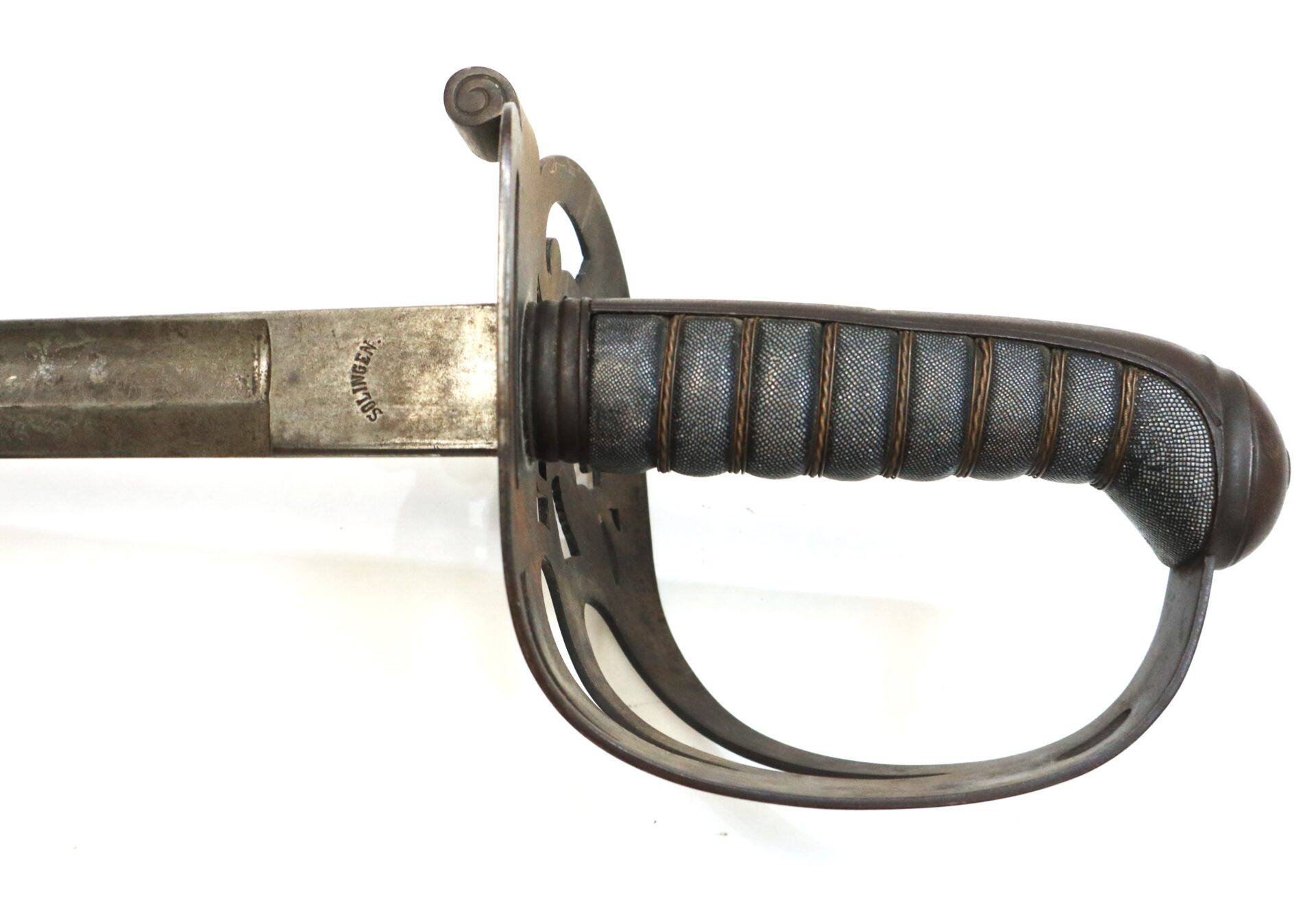 Close-up view of the hilt and partially blade of a vintage sword with a metal guard and textured grip against a white background.