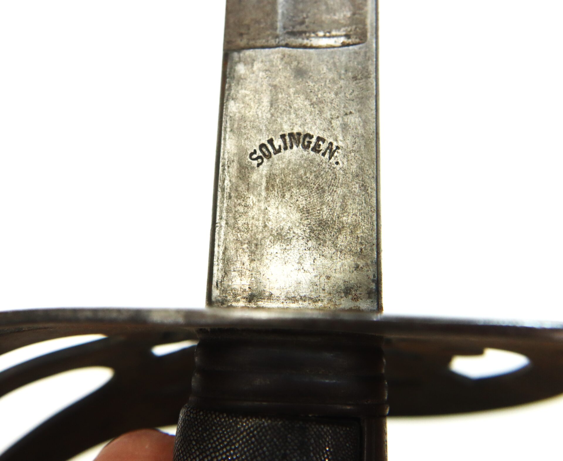 Close-up of a metal sword blade stamped with the word "SOLINGEN" above the hilt, with part of the guard and grip visible.