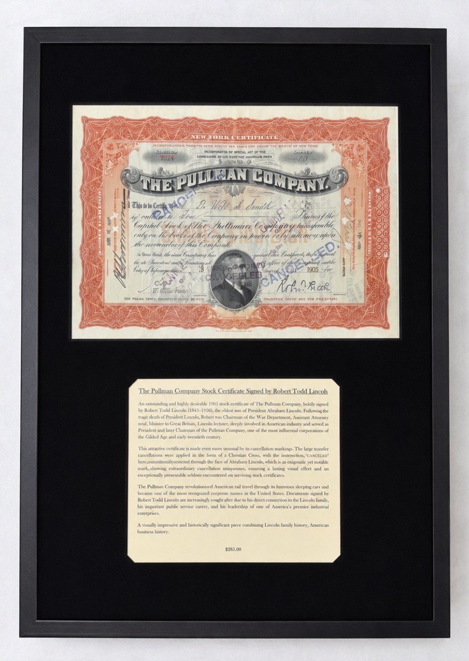 Framed Pullman Company stock certificate with an ornate orange border and a central portrait, displayed above an informational plaque about the certificate and its signatory.