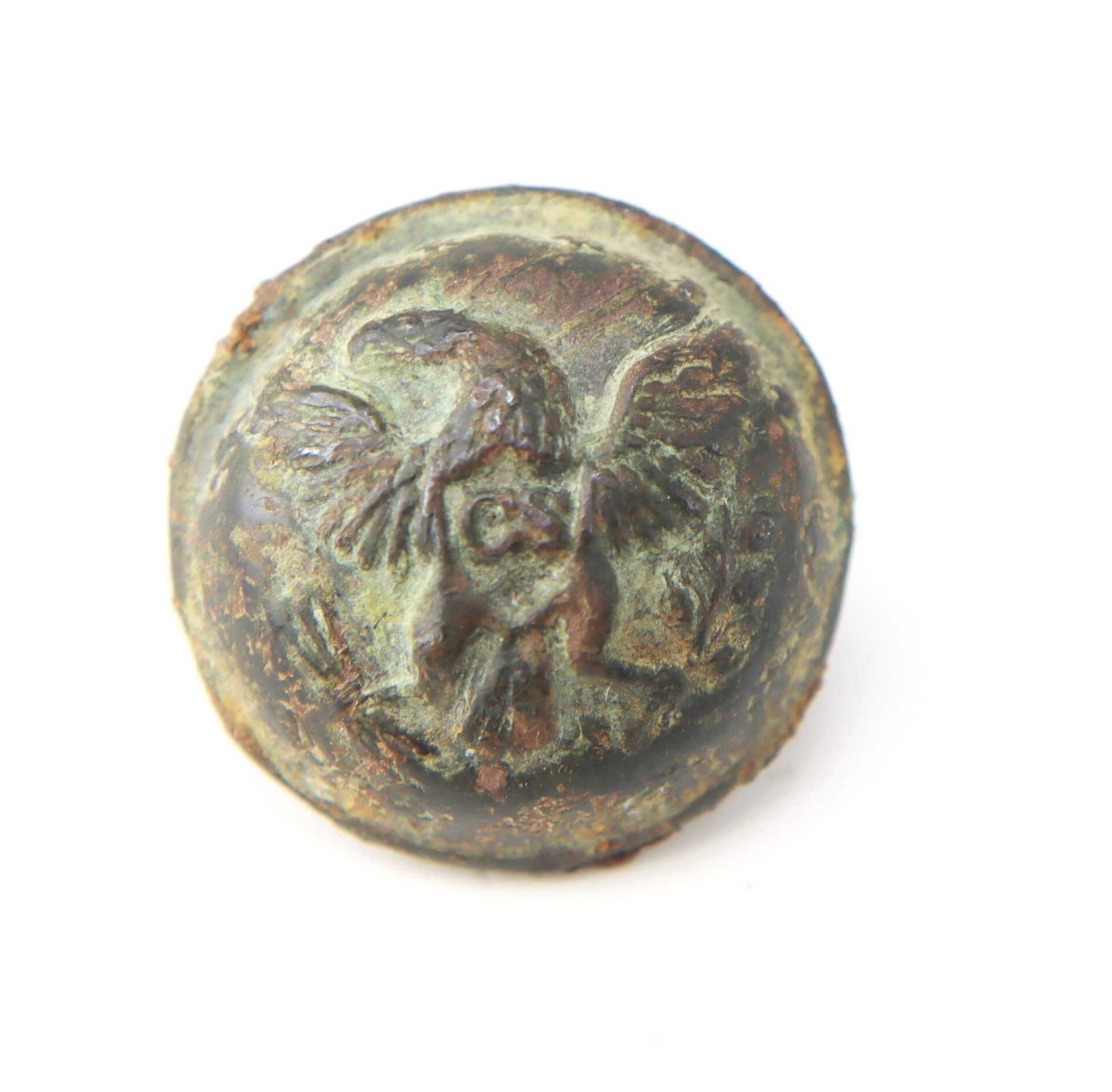 Round, weathered metal button featuring a raised eagle with outstretched wings, showing signs of oxidation and corrosion.