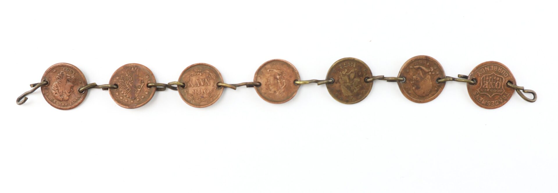 A bracelet made from seven linked coins with metal loops attaching each coin.