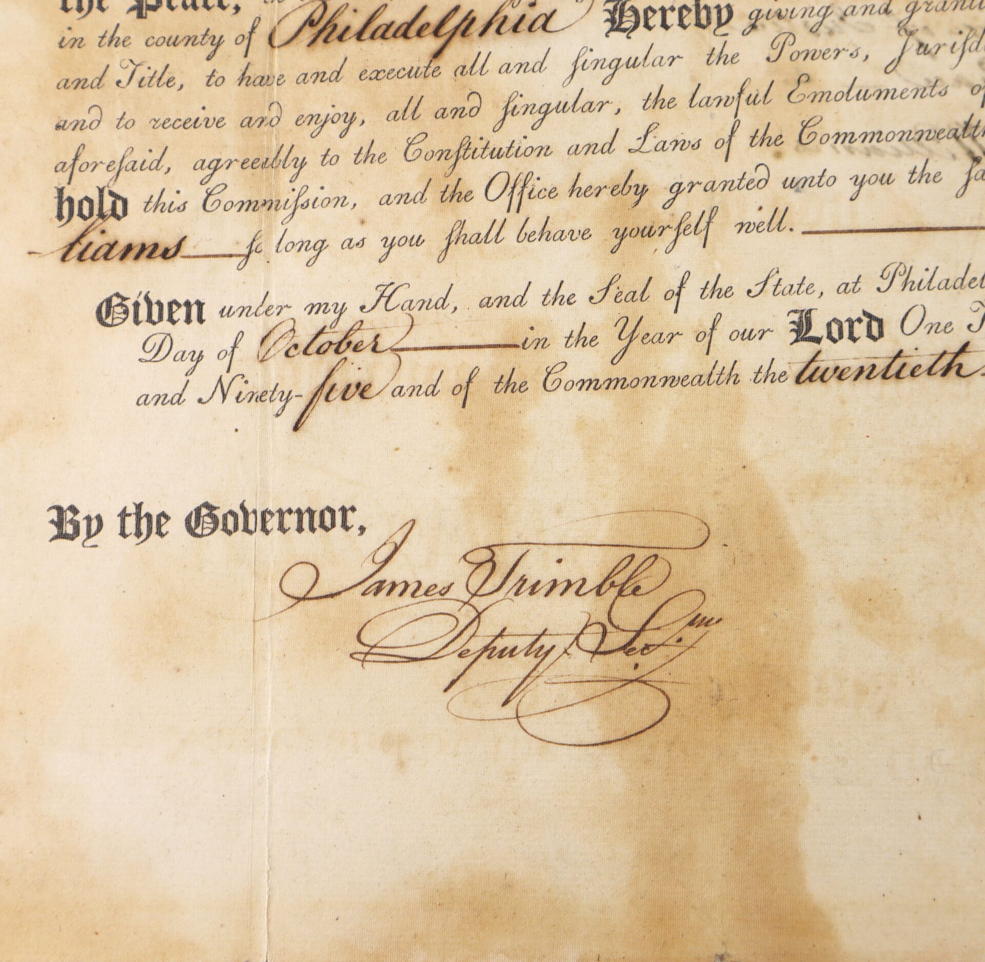 A close-up of an old official document showing signatures, handwritten words, and the seal of the Commonwealth of Pennsylvania.