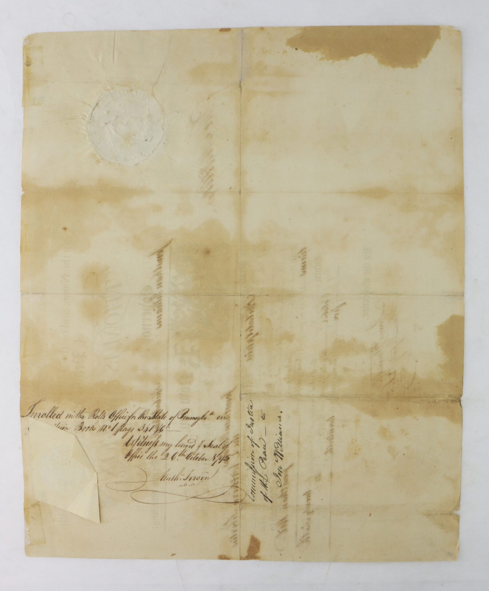 Aged, yellowed document with handwritten text, visible creases, water stains, and an embossed seal at the upper left corner.
