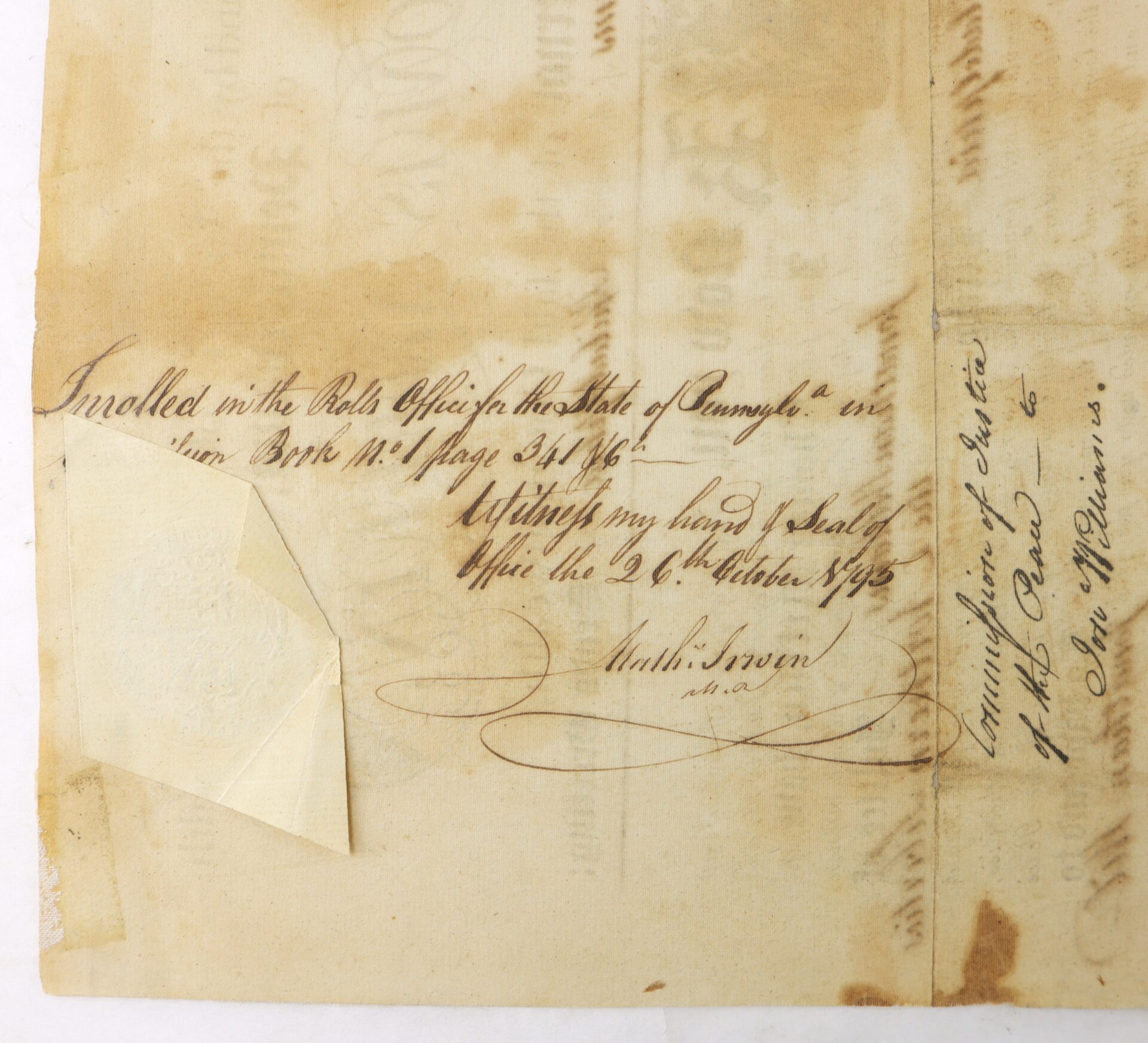 A handwritten note on old paper records enrollment in the Rolls Office, State of Rumple, dated October 29, 1765, with signatures and a folded paper seal attached.