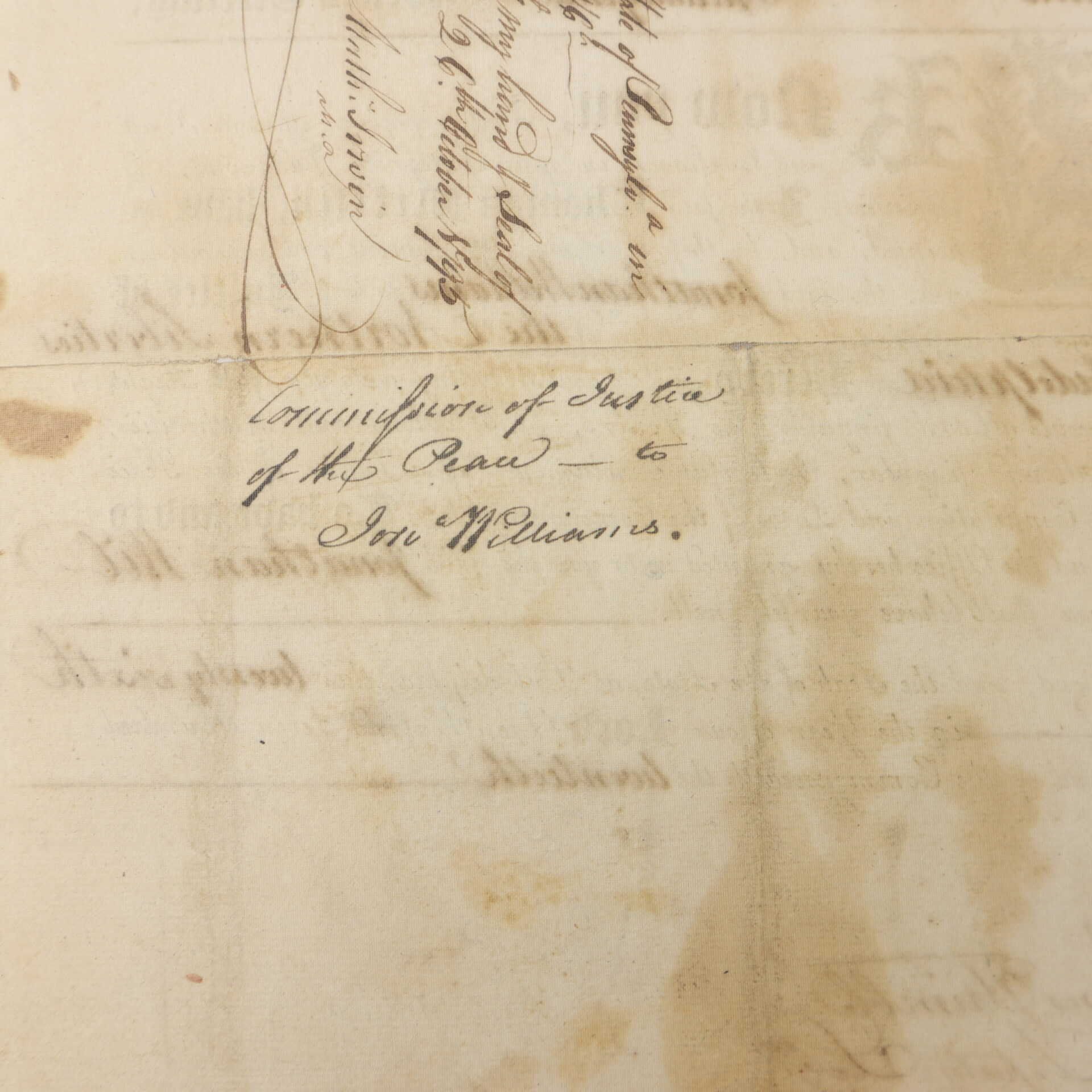 A handwritten document reads, "Commission of Justice of the Peace to Jon Williams," with additional faded text and signatures visible.